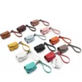 PU leather wireless earphone case detail view with handy strap in multiple vibrant colors - Light Blue