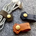 Leather cat paw cable winder detail view, cute cord organizer for earphones and data lines. - Yellow