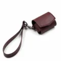 Wine red PU leather AirPods case with wrist strap, portable protective cover for wireless earphones. - Burgundy
