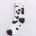 Comfortable cotton mid-calf socks featuring a cute black and white cow print pattern design. - One Size / White