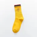 Close-up detail of yellow cotton crew sock featuring red embroidered camera no symbol. - One Size / Yellow