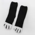 Fluffy black coral fleece socks featuring cute white cat paw design for cozy winter warmth. - One Size / Black