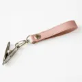 Pink leather baby shoe clip and stroller strap, durable metal clasp for secure use. - Pink