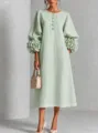 Detailed view of the elegant light green midi dress featuring 3D flower lantern sleeves. - Light Green