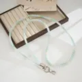 Colorful TPU telephone cord phone lanyard detail shot, pastel coiled strap with metal clasps. - Gradient Green