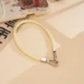 PU leather wrist strap phone lanyard detail shot, featuring stylish yellow color and metal clasps. - Light Yellow