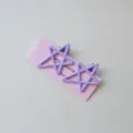 Detail view of cute candy color star hair clips with duckbill design for sweet girl styling. - 2 Pieces/Pack / Purple