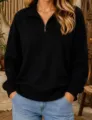 Close-up detail of casual black half-zip long sleeve sweatshirt fabric and collar zipper design. - S / Tops / Black