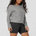 Detail view of women's solid grey long sleeve crewneck top paired with black shorts, soft knit fabric. - S / Tops / Gray