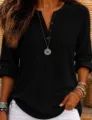 Close-up detail of women's black waffle knit long sleeve henley shirt with button front design. - S / Tops / Black