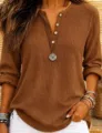 Detail view of a solid brown waffle knit long sleeve henley top with button placket styling. - S / Tops / Caramel color