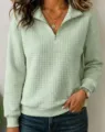 Detailed view of women's casual solid color waffle knit quarter-zip long sleeve sweatshirt. - Light Green