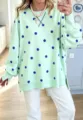 Mint green long sleeve sweatshirt detail with blue polka dots and a relaxed casual style. - Mint Green