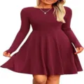 Detail view of women's long sleeve ribbed dress in red, showing the flared silhouette. - Burgundy