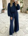 Outdoor scenic detail view of a cozy dark blue polka dot loungewear set with wide legs. - Navy Blue