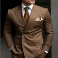 Close-up view of a stylish brown double-breasted men suit jacket with matching shirt and tie. - S / Top And Bottom / Brown