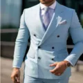 Detailed close-up shot of the stylish light blue double-breasted men's suit jacket. - S / Top And Bottom / Light Blue