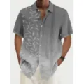 Vista cercana que muestra los detalles del estampado de hojas y rayas en la camisa. - 5XL / Tops / Gris Patchwork (0003)