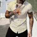 Detailed view of the stylish men's short sleeve shirt with gold splatter print design. - Gold Ink Splash Print