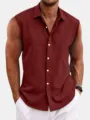 Men's burgundy sleeveless button-down shirt detail showing textured fabric and classic lapel. - Red