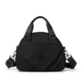 Black nylon crossbody bag with top handles, multi-layer design and adjustable strap. - Black