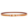 Close-up detail of a slim brown leather belt featuring a sleek golden metal buckle design. - Horsebit Buckle / Camel