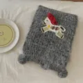 Closeup of grey fluffy knitted scarf featuring cute embroidered horse patch and cozy texture. - 18x160cm / Light Gray