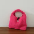 Détail du sac à main en tricot duveteux rose avec texture mohair douce et bouton élégant. - Fruit du Dragon