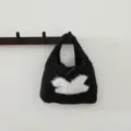 Gros plan du sac à main en tricot duveteux noir avec motif de lapin blanc et bouton. - Noir Classique