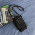 Black mountain-style drawstring mini crossbody bag with elastic cord, casual daily wear. - Black