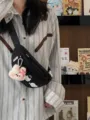 Black canvas chest bag detail, cute plush rabbit pendant, casual crossbody lifestyle shot. - With Charm / Black