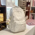 Stylish white student backpack with colorful patterns, casual daily school bookbag for teens. - Smiling Star Pendant / White