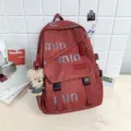 Red canvas backpack for women and students with stylish abstract print and cute bear pendant. - Charm / Burgundy