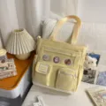 Korean style canvas tote bag for students with cute bear badges and multiple pockets. - Cram School Bag with Pendant / Yellow