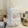 Japanese sweet white ita backpack with star pattern, front mesh pocket for pins and daily use. - With Pendant And Heart Badge / White