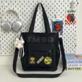 Black canvas shoulder bag, large capacity fashion casual student tote bag with stylish patches. - Shoulder Bag - With Pendant / Black