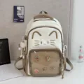 Cute cat canvas backpack with clear front pocket for women, large capacity school bag. - Brown + Long-legged Plush Ball