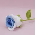 Detailed close-up of handmade crochet blue and white gradient rose flower with green leaf. - Gradient Blue
