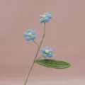 Handmade crochet blue flower stem detail close up for home decor and desktop ornament - Blue