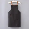 Black canvas apron with brown straps and front pocket for kitchen cooking and work wear use - Regular Fit / Black