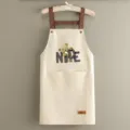 Delantal de cocina impermeable con osito tierno y estampado NICE, tirantes y bolsillos marrones. - Oso NICE Beige