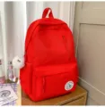 Red canvas backpack for school girls, casual minimalist daypack with cute fluffy keychain. - Long Legged White Fur Ball / Red