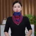 Detailed view of the warm knitted triangular scarf featuring a stylish magnetic gold ball clasp. - Blue Red