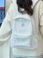 Detail view of Japanese style striped canvas backpack showing front pocket, cute patch and straps. - Blue
