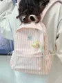 Detail view of the pink striped canvas backpack featuring a cute plush pendant and pockets. - With Pendant / Pink
