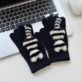 Detailed close-up shot of winter warm black knitted gloves featuring cute furry striped cat tail. - One Size / Black