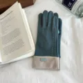Detail view of winter thermal touch screen gloves with stylish contrast color and white stitching. - One Size / Teal