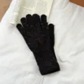 Close-up detail of warm knitted speckled winter gloves showcasing fine texture and soft material. - One Size / Black