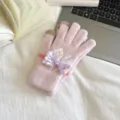 Pink knitted touchscreen gloves detail view featuring an elegant purple lace bow decoration for women. - One Size / Pink