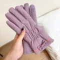 Close-up detail of winter warm touch screen gloves with cute bow design, soft fleece lining. - One Size / Purple